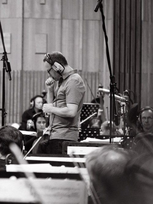Daniel Alcheh listening on headphones during an orchestral recording session